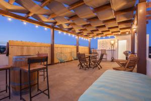 a room with a bed and tables and chairs at Aquamarina in La Paz
