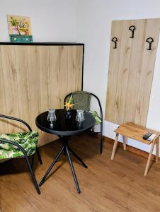 a black table and chairs in a room at GuestHouse2 Karma369 in Plovdiv