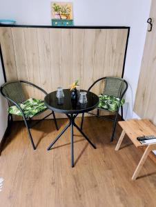 two chairs and a table with a vase on it at GuestHouse2 Karma369 in Plovdiv