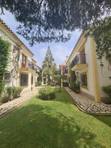 a courtyard of a building with a green yard at Casa sol y mar in Vera