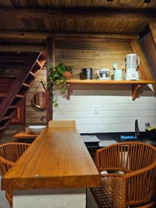 a kitchen with a wooden table and two chairs at Cabana Redonda Beach in Icapuí
