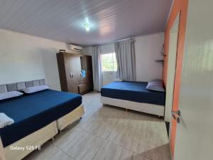 a bedroom with two beds and a window at Bom sossego in Foz do Iguaçu +21 photos