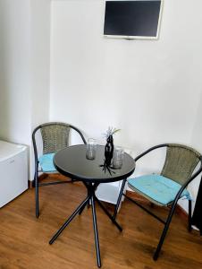 a table with two chairs and a table with a vase on it at GuestHouse5 KARMA369 in Plovdiv +12 photos