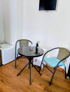a table and chairs in a room with a table at GuestHouse5 KARMA369 in Plovdiv