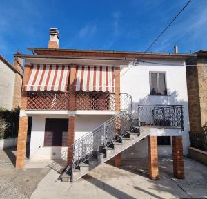 a white house with a staircase in front of it at Casa di Nonna Angela in Guadamello +11 photos