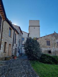 an alley in an old building with a tower at Casa di Nonna Angela in Guadamello