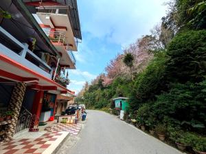 an empty street next to a building at Chamling Retreat in Kalimpong