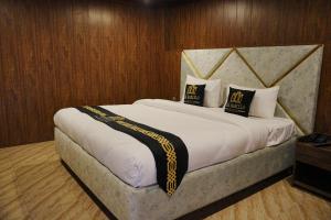 a bedroom with a large bed with two pillows on it at The Barcelo Apartment & Cottages in Naran