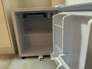 an empty refrigerator with its door open in a kitchen at Colombo - Kelaniya House in Kelaniya