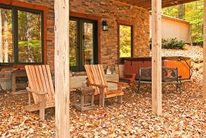 a patio with two chairs and a table and a fireplace at Timber Ridge in Franklin +6 photos