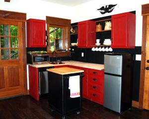 a kitchen with red cabinets and a stainless steel refrigerator at Timber Ridge in Franklin