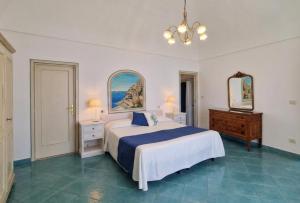 a bedroom with a large bed and two mirrors at Casa Guadagno in Positano +108 photos