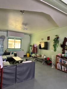 a living room with a couch and a table at Caye Caulker Plaza Hotel in Caye Caulker