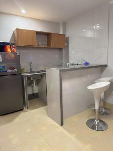 a small kitchen with a sink and a counter at Peruyork - Sauna & Jacuzzi in Chiclayo