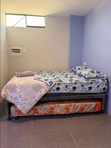 a bedroom with a bed in a room at Peruyork - Sauna & Jacuzzi in Chiclayo