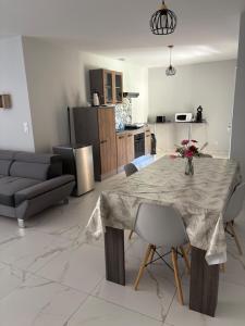 a kitchen and living room with a table and chairs at Maison perthois in Saint-Dizier +2 photos