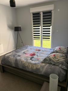 a bed sitting in a room with a window at Maison perthois in Saint-Dizier