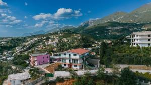 a town on a hill with mountains in the background at Tirana SkyView in Tirana