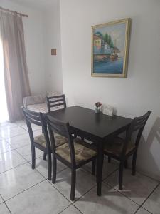 a black dining room table and chairs in a room at Apartment with view at Olympus mountain in Litochoro