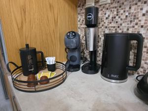 a counter with a coffee maker and a coffeemaker at Rosemary Guesthouse in Kavála +9 photos