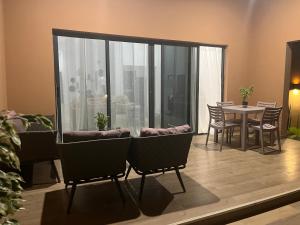 a living room with chairs and a table with a view at Villa Abou in Assinie +7 photos