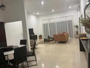 a living room with a couch and a table at Villa Abou in Assinie