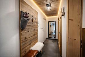 a hallway with a wood paneled wall and a bench at OLDWOOD CHALET - Design Chalet & Balcony in Fügen