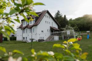a large white house with a gambrel roof at Villa Swarzewo in Swarzewo