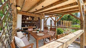 a wooden patio with a table and chairs at Vila EVIO Třeboň in Třeboň