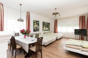 a living room with beds and a table and chairs at Villa Swarzewo in Swarzewo