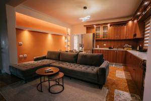 a living room with a couch and a kitchen at Tirana SkyView in Tirana