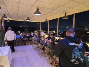 a group of people sitting at tables in a room at nova pyramids inn in Cairo +236 photos