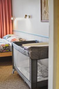a room with two beds and a desk with a sink at Metsa Hostel in Võsu