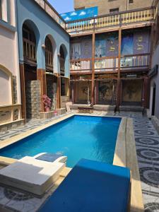 a swimming pool in front of a building at nova pyramids inn in Cairo