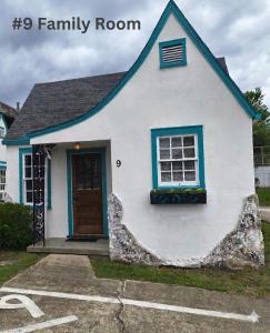 a white house with a window and a door at Crescent Court in Branson +2 photos
