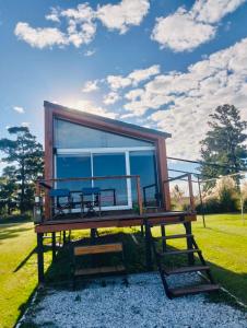 a tiny house with a large window on display at Melincue Arenas in Melincué