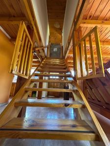 a staircase in a house with wooden ceilings at Rincon de Ñires cabaña 4 in San Martín de los Andes