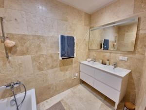 a bathroom with a white sink and a mirror at Apt Belvedere in Apt +10 photos