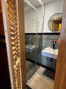 a bathroom with two sinks and a mirror at L' Ecole in Durbuy +90 photos