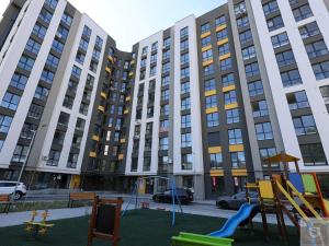 an empty playground in front of a large building at RentHouse Apartments Panoramic-Airport-Studio in Chişinău
