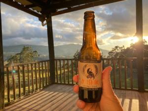 a person holding a bottle of beer on a deck at Pakarina WASY in San Miguel +10 photos