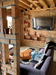 a living room with a couch and a brick wall at Pakarina WASY in San Miguel