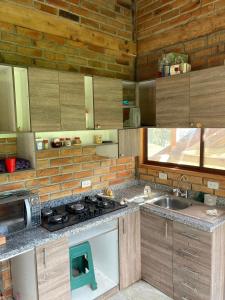 a kitchen with a sink and a stove top oven at Pakarina WASY in San Miguel
