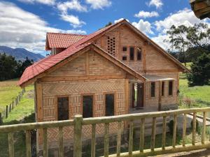 a small wooden house with a wooden fence at Pakarina WASY in San Miguel