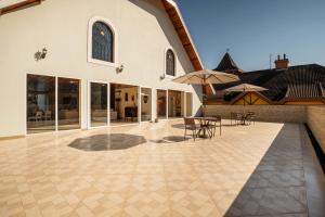 a patio with tables and umbrellas on a building at Pousada Sol da Mantiqueira in Campos do Jordão