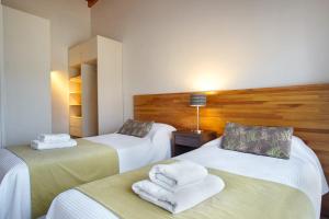 a hotel room with two beds with towels on them at Balcones al Nahuel II in San Carlos de Bariloche