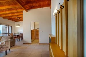 a kitchen and living room with wooden ceilings at Balcones al Nahuel II in San Carlos de Bariloche