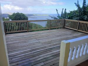 a wooden deck with a view of the ocean at Yellow Leaf Suite in West End