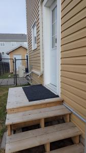 a wooden porch with a door on a house at Beautiful Home for all in Moncton