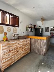 a kitchen with a large wooden counter in a room at Lounge Vila Tatajuba in Tatajuba